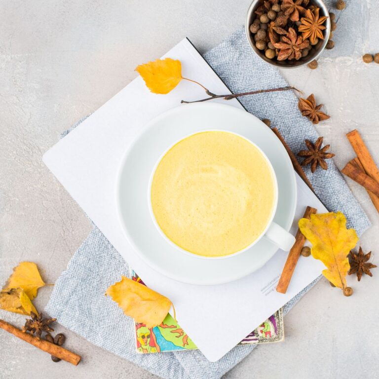 golden turmeric latte with spices on table