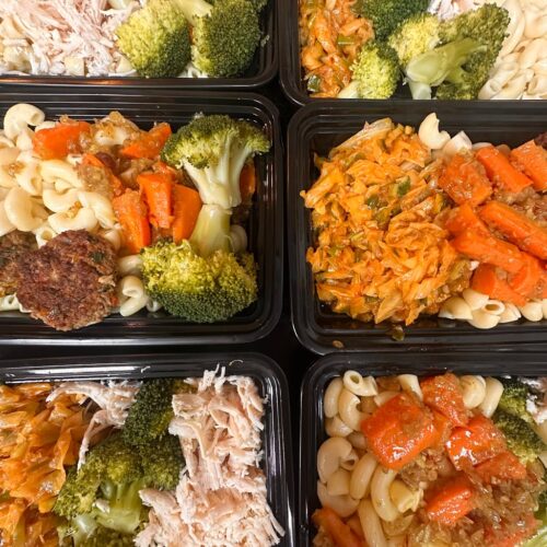 healthy meal prep trays with pasta and vegetables
